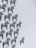 A close up of the dala horse map, where the horse for Stockholm is gold foiled. 