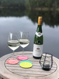Two wineglasses and a bottle of wine by the lake, a set with four coaster in summery colors that say Skål